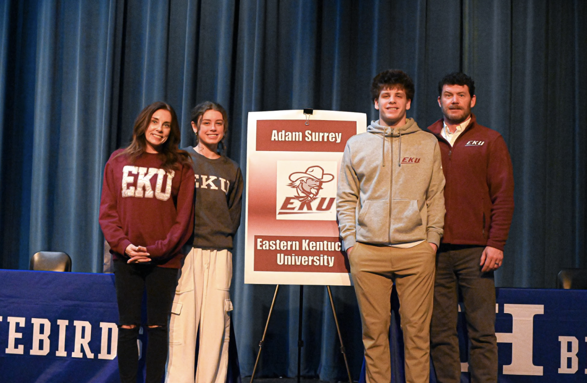 Adam Surrey (12) poses for a photo with his family after signing to Eastern Kentucky University. “I chose this college because it is close to home,” Surrey said. 